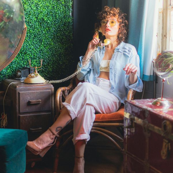 Image of a person sitting on a chair calling someone on the phone, representing how easy it is to get started with NeuroSpark Health.